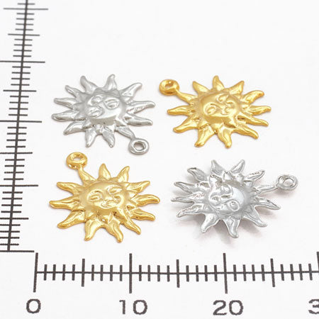 Brass charm, solar rhodium, color.